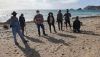 Voluntarios limpian la playa de las Palmeras de San Juan de los Terreros